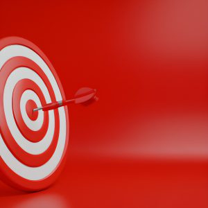 3D-Illustration einer rot-weißen Dartscheibe mit einem Pfeil im Bullseye vor rotem Hintergrund